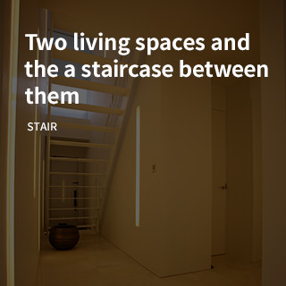 Two living spaces and the a staircase between them